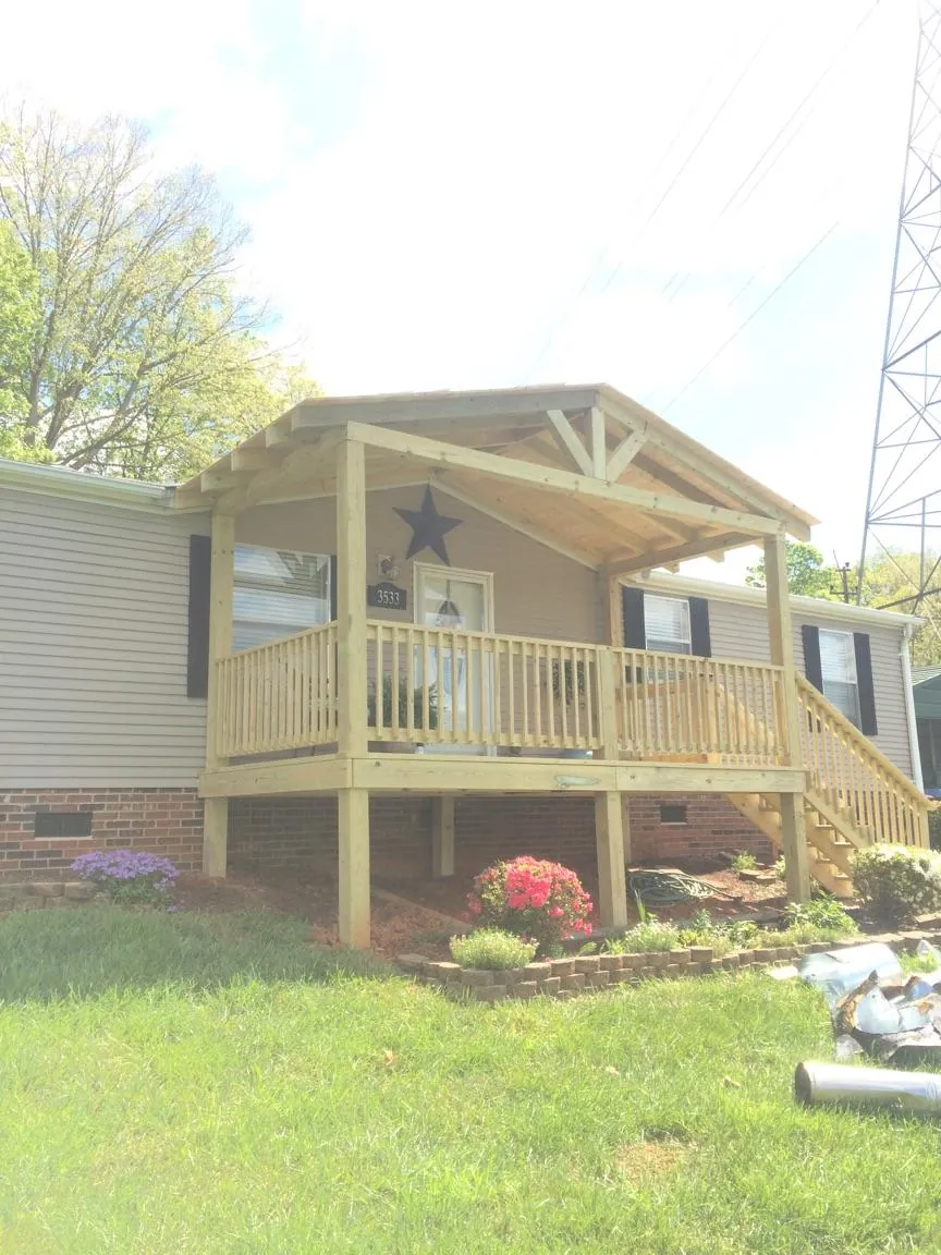New gabled porch roof and deck railing added to a ranch home in Leland